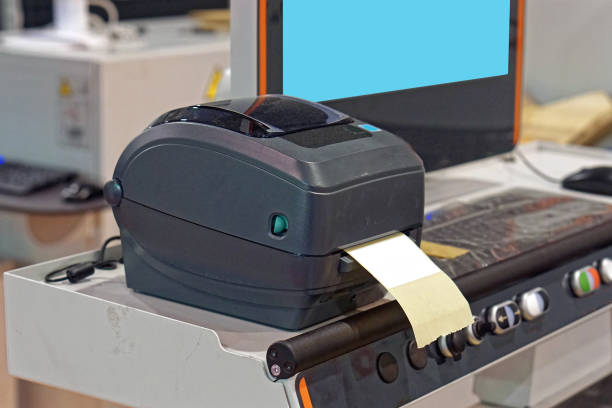 Label printer at machine in factory production