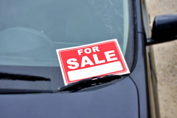 A For Sale sign in a car window.